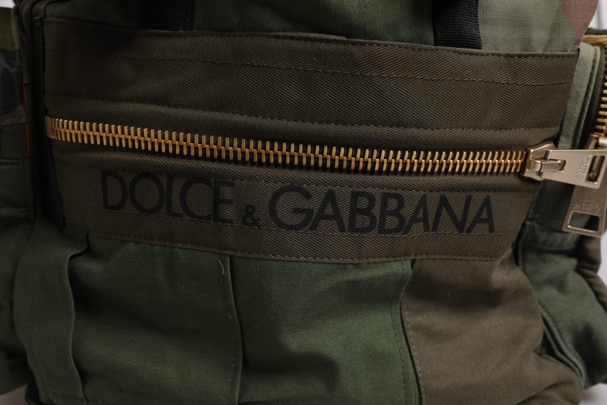 Large Travel Drawstring Backpack by Dolce & Gabbana for men in cotton & leather military-green, camouflage & patchwork features a stately Cotton Leather Large Travel Drawstring Backpack design, showcasing a secure drawstring, ample internal-pockets, and versatile backpack-strap for a stately finish.