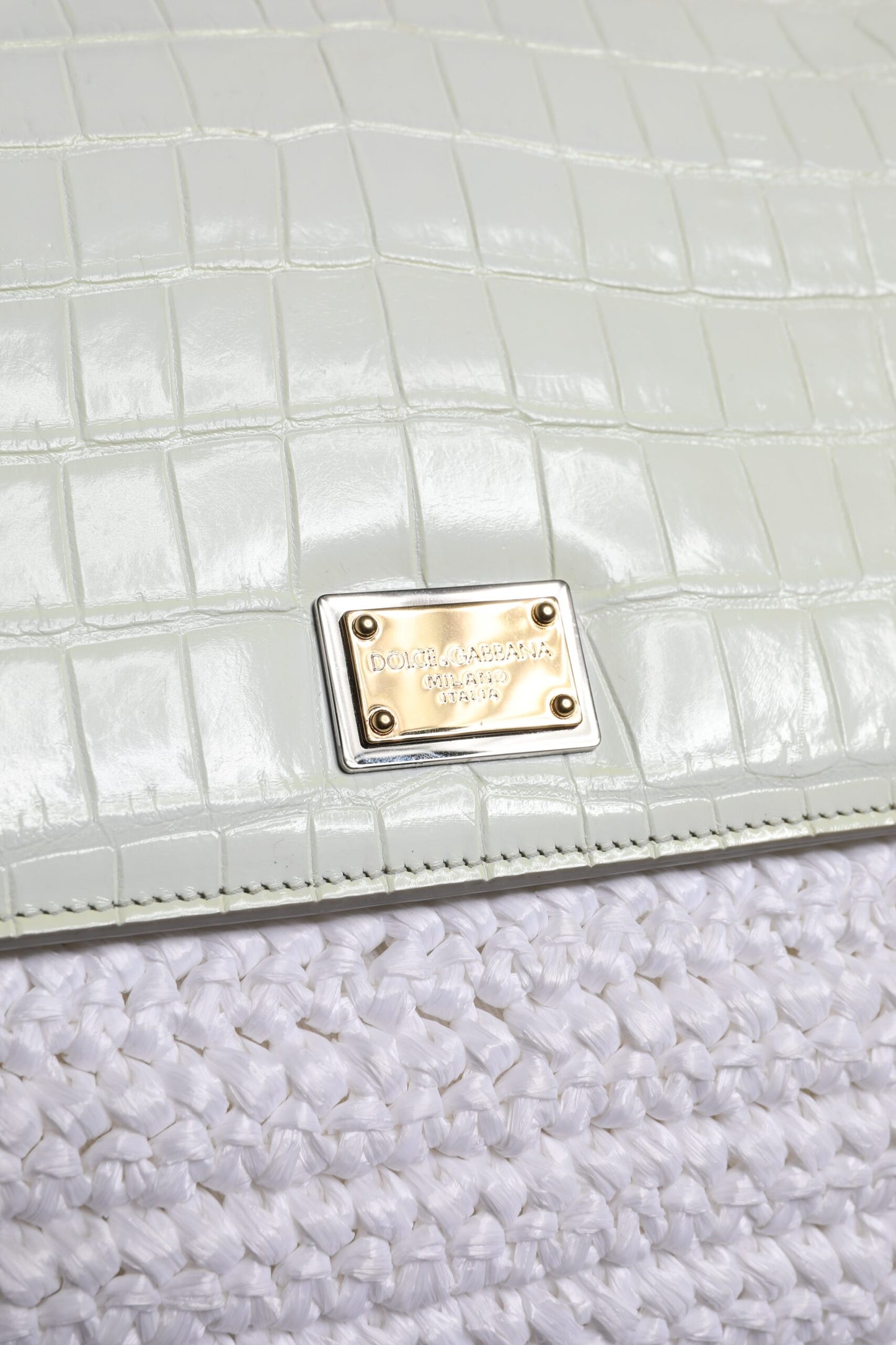 Crossbody Handbag by Dolce & Gabbana for women in raffia & leather gold & white features a versatile chic silhouette, meticulously detailed with a secure magnetic, ample , and versatile crossbody-strap, shoulder-strap, handle, adjustable-strap & detachable-strap.