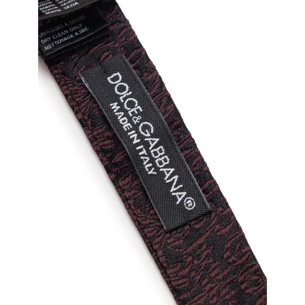 Necktie by Dolce & Gabbana for men in silk black & purple features a distinguished silhouette, artfully capturing the essence of the distinguished Silk Necktie design for a sophisticated look.