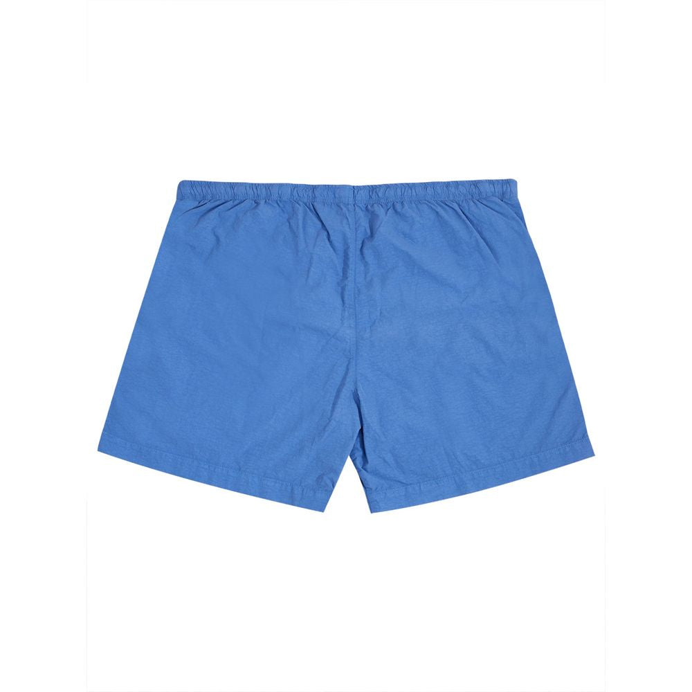 Swim Shorts by C.P. Company for men in polyamide blue showcases a captivating silhouette, expertly capturing the sophisticated essence of the captivating Essence Men's Polyamide Swim Shorts design for a premium poolside look.