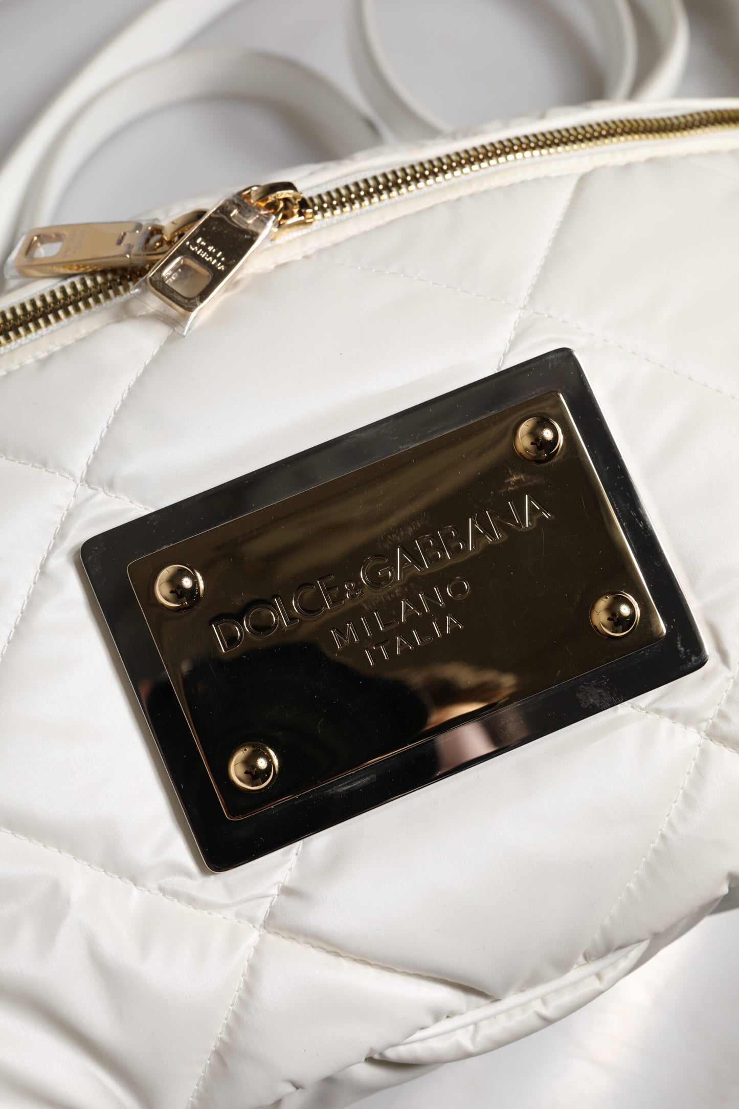 Quilted Fanny Pack Belt Bag by Dolce & Gabbana for women in calf leather & nylon gold & white presents a jet-setting Calf Leather Nylon Quilted Fanny Pack Belt Bag design with a secure zipper, ample , and versatile handle, adjustable-strap, detachable-strap & belt-strap for a jet-setting finish.