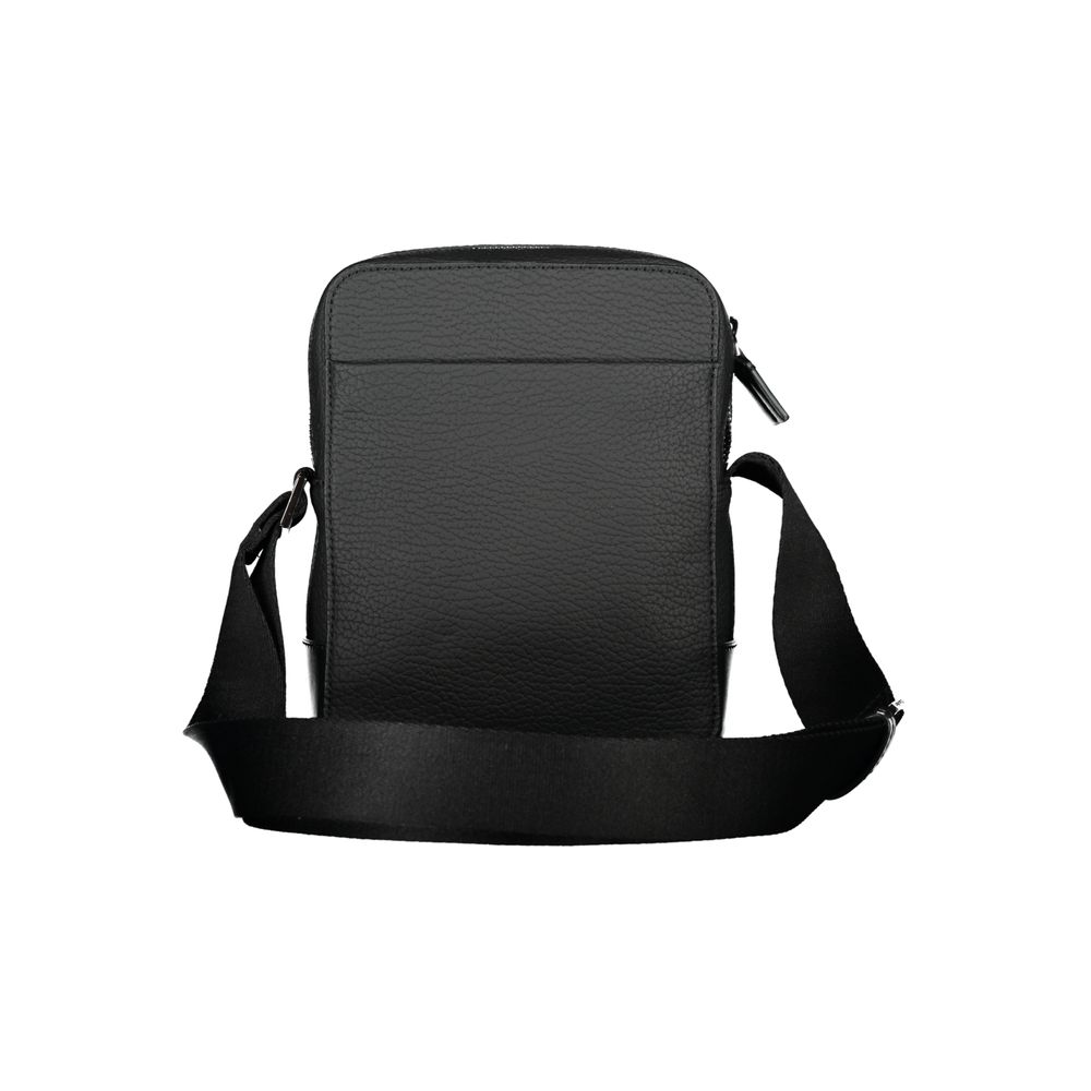 Shoulder Bag by Calvin Klein for men in polyester & polyethylene black features an effortlessly chic silhouette with a secure zipper, ample external-pockets & internal-pockets, and versatile shoulder-strap & adjustable-strap for effortlessly chic everyday luxury.