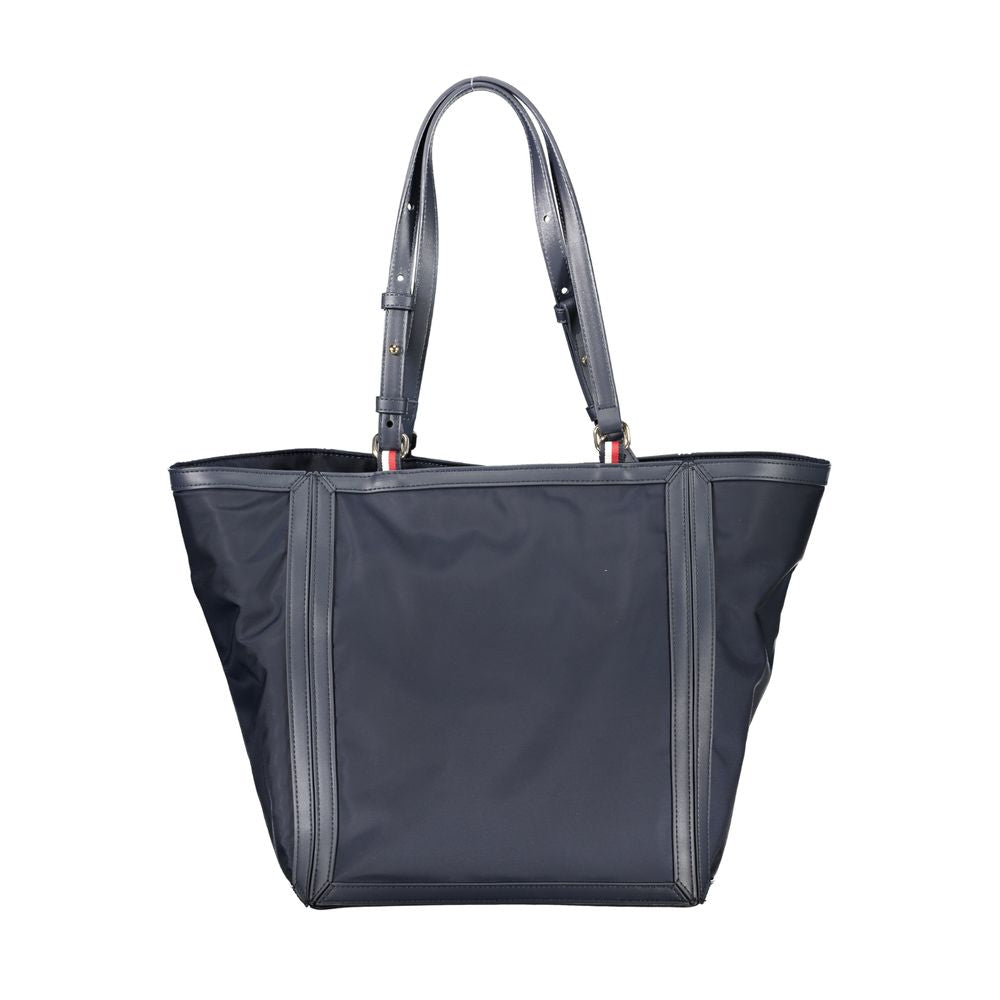 Shopper Tote Convertible Handbag by Tommy Hilfiger for women in polyester blue presents a enviable design with a secure zipper, ample internal-pockets, and versatile adjustable-strap & handle for a sophisticated look.