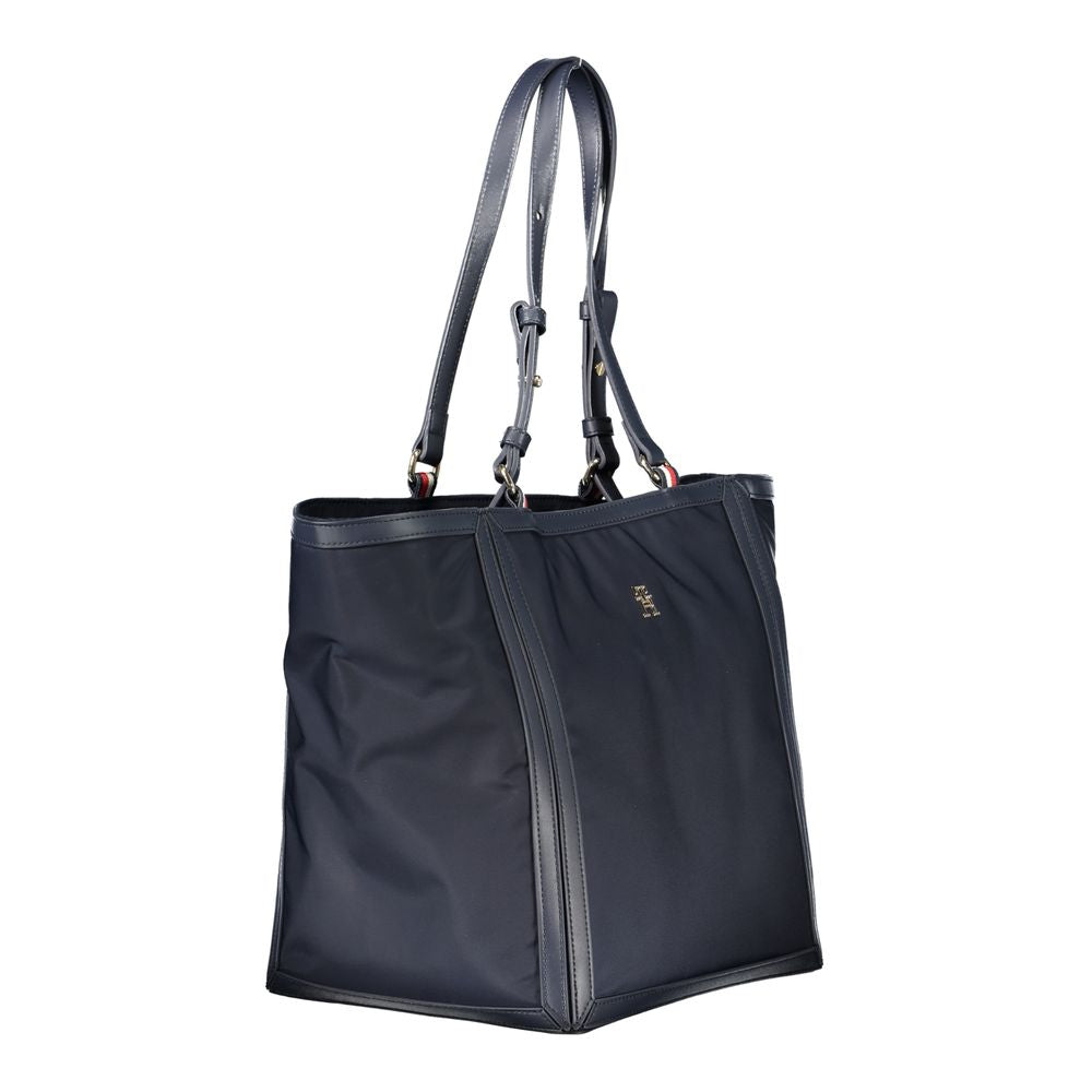 Shopper Tote Convertible Handbag by Tommy Hilfiger for women in polyester blue features a exquisite silhouette with a secure zipper, ample internal-pockets, and versatile adjustable-strap & handle for a exquisite look.