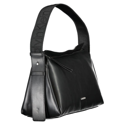 This Shoulder Handbag by Calvin Klein for women in polyester faux leather and black presents a sculptural silhouette featuring a secure zipper, ample document-holder, and versatile shoulder-strap, adjustable-strap & handle for a sculptural finish.
