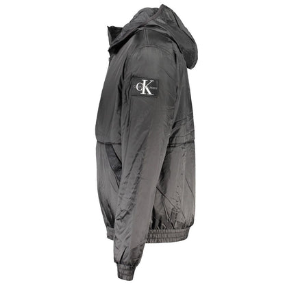 Hooded Windbreaker Jacket by Calvin Klein for men in polyester black presents a resilient silhouette, artfully detailed with a sophisticated hooded neckline and functional pockets, hooded & windproof for a resilient finish.