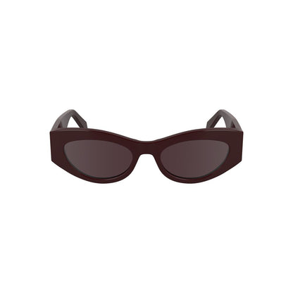 Sunglasses by Calvin Klein for women in and brown & red presents a sumptuous silhouette, featuring red coloured frame and cat-eye frame design with for a sumptuous look.