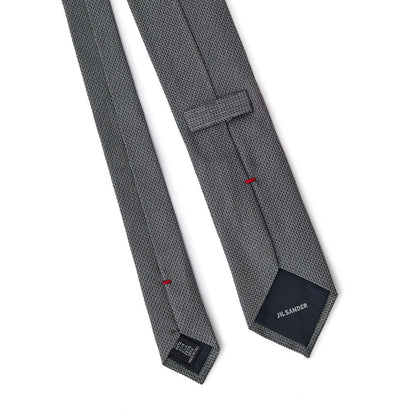 Necktie by Jil Sander for men in silk gray & jacquard features an stately silhouette that beautifully highlights the sophisticated style of the Silk Necktie.