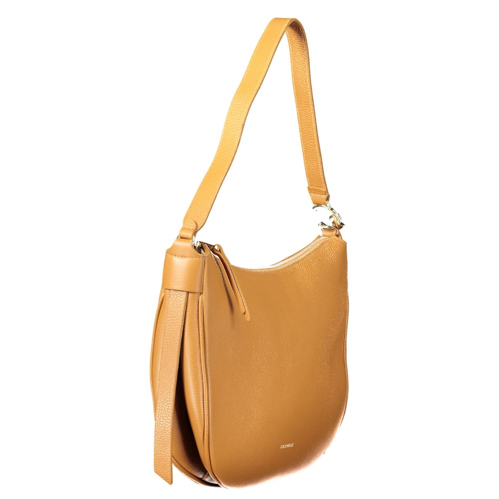 This Shoulder Handbag by Coccinelle for women in leather and brown presents a sculptural silhouette featuring a secure zipper, ample internal-pockets, and versatile shoulder-strap & handle for a sculptural finish.