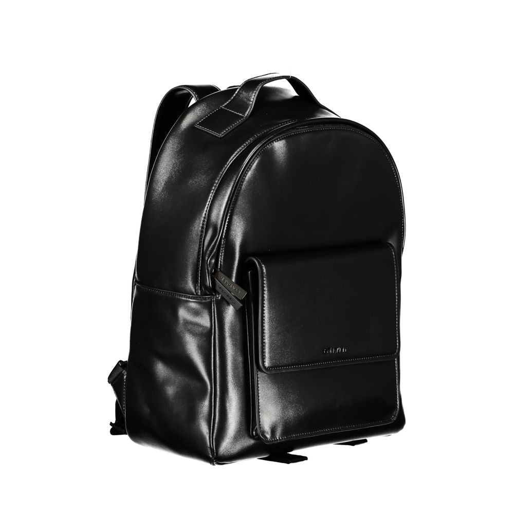 Backpack by Calvin Klein for men in polyester & polyethylene black showcases an architectural Polyester & Polyethylene Backpack design, featuring a secure zipper, ample built-in-compartments, external-pockets, internal-pockets & laptop-compartment, and architectural backpack-strap, adjustable-strap & handle for a sophisticated look.