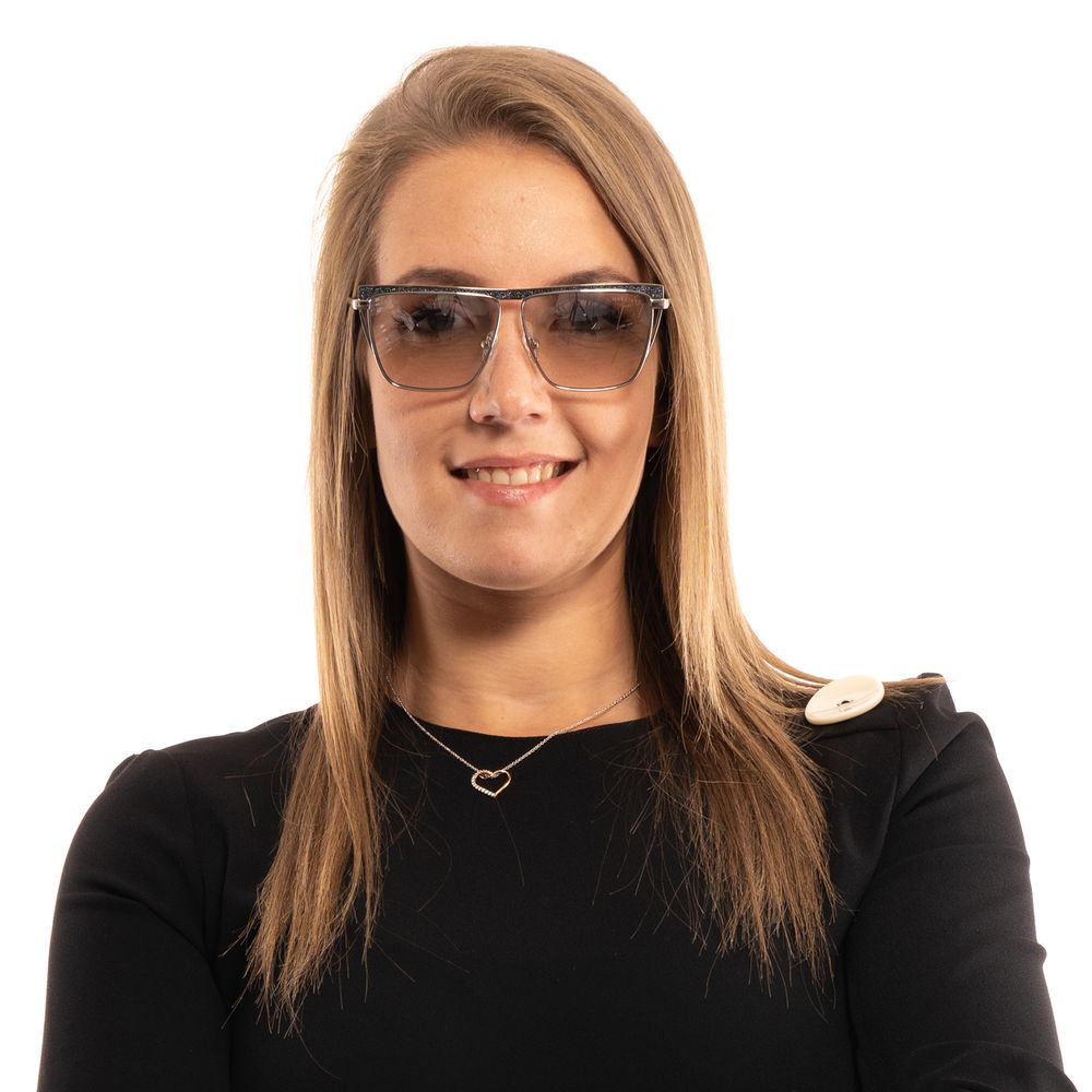 This Sunglasses by Marciano by Guess for women in silver presents a sumptuous silhouette, showcasing a sumptuous trapezium frame design in silver coloured frame and high-performance mirrored category-1-light-tint lens.