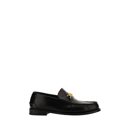 This Loafer Shoes by Versace for men in bos taurus calf leather black features an exquisite silhouette from the Medusa Men's Bos Taurus Calf Leather Loafer Shoes collection, defined by a sophisticated block-heel and elegant round toe style.