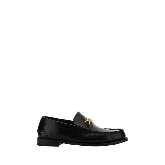 This Loafer Shoes by Versace for men in bos taurus calf leather black features an exquisite silhouette from the Medusa Men's Bos Taurus Calf Leather Loafer Shoes collection, defined by a sophisticated block-heel and elegant round toe style.