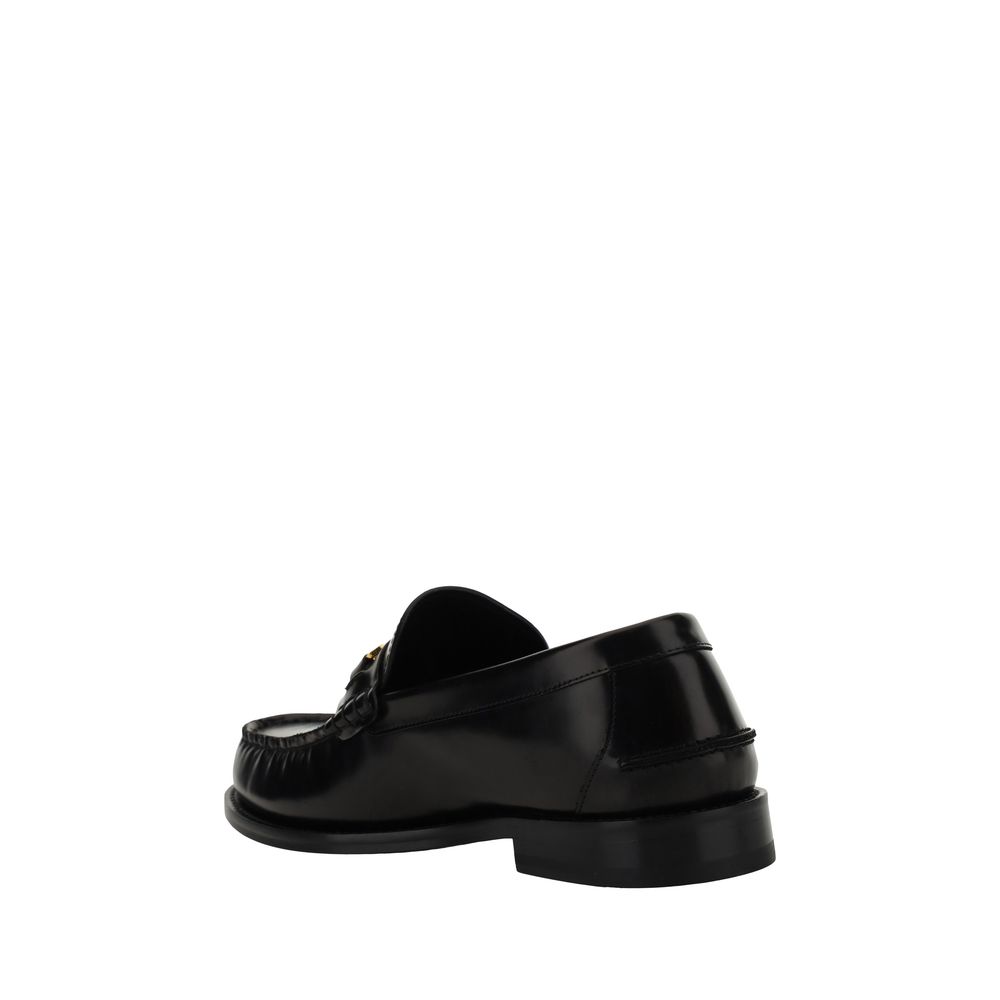 Loafer Shoes by Versace for men in bos taurus calf leather black features an effortless chic silhouette, showcasing the Medusa Men's Bos Taurus Calf Leather Loafer Shoes design with an effortless chic block-heel and a round toe style for a effortless chic look.