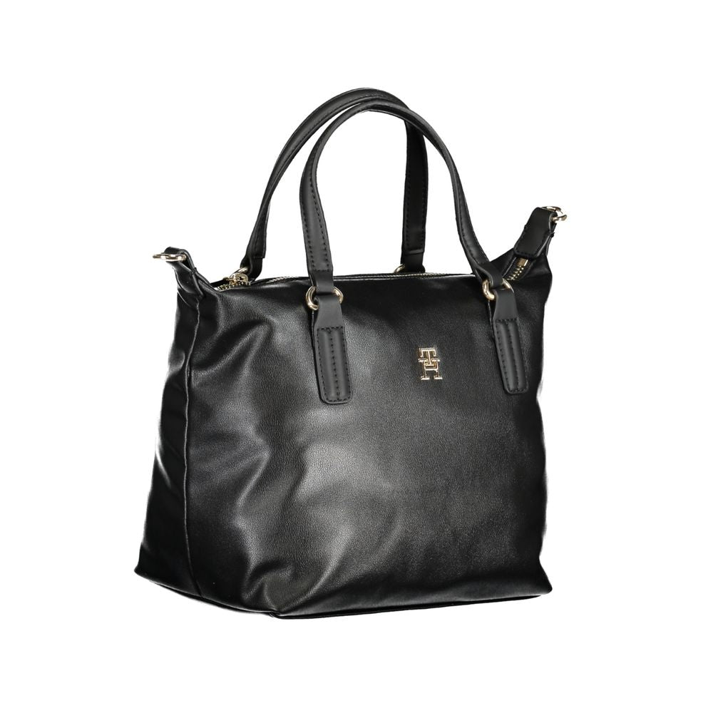 Handbag by Tommy Hilfiger for women in polyester black features a signature silhouette, showcasing a secure zipper and signature internal-pockets with versatile shoulder-strap, handle & adjustable-strap for a sophisticated look.