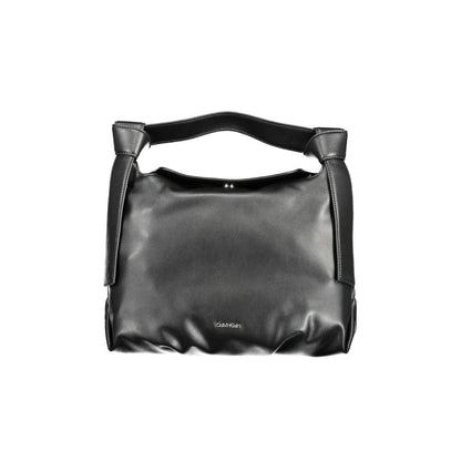 This Satchel Handbag by Calvin Klein for women in polyester faux leather and black presents a sculptural silhouette featuring a secure snap, ample internal-pockets, and versatile shoulder-strap, adjustable-strap & handle for a sculptural finish.