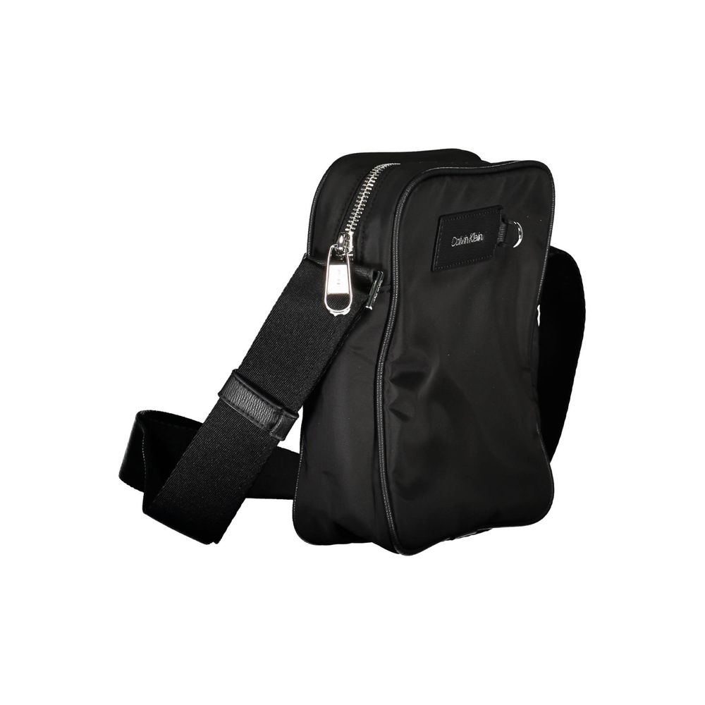 Shoulder Bag by Calvin Klein for men in polyester black showcases a statuesque silhouette, artfully detailed with a secure zipper, organized internal-pockets, and versatile shoulder-strap & adjustable-strap for a statuesque look.