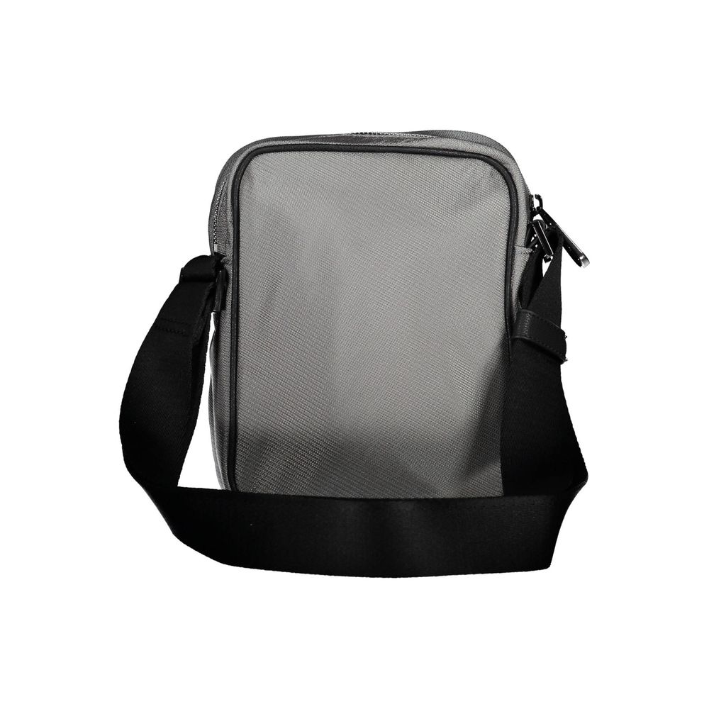 Shoulder Bag by Calvin Klein for men in polyester gray features a stately silhouette, showcasing a secure zipper, ample external-pockets & internal-pockets, and stately shoulder-strap & adjustable-strap for a stately finish.