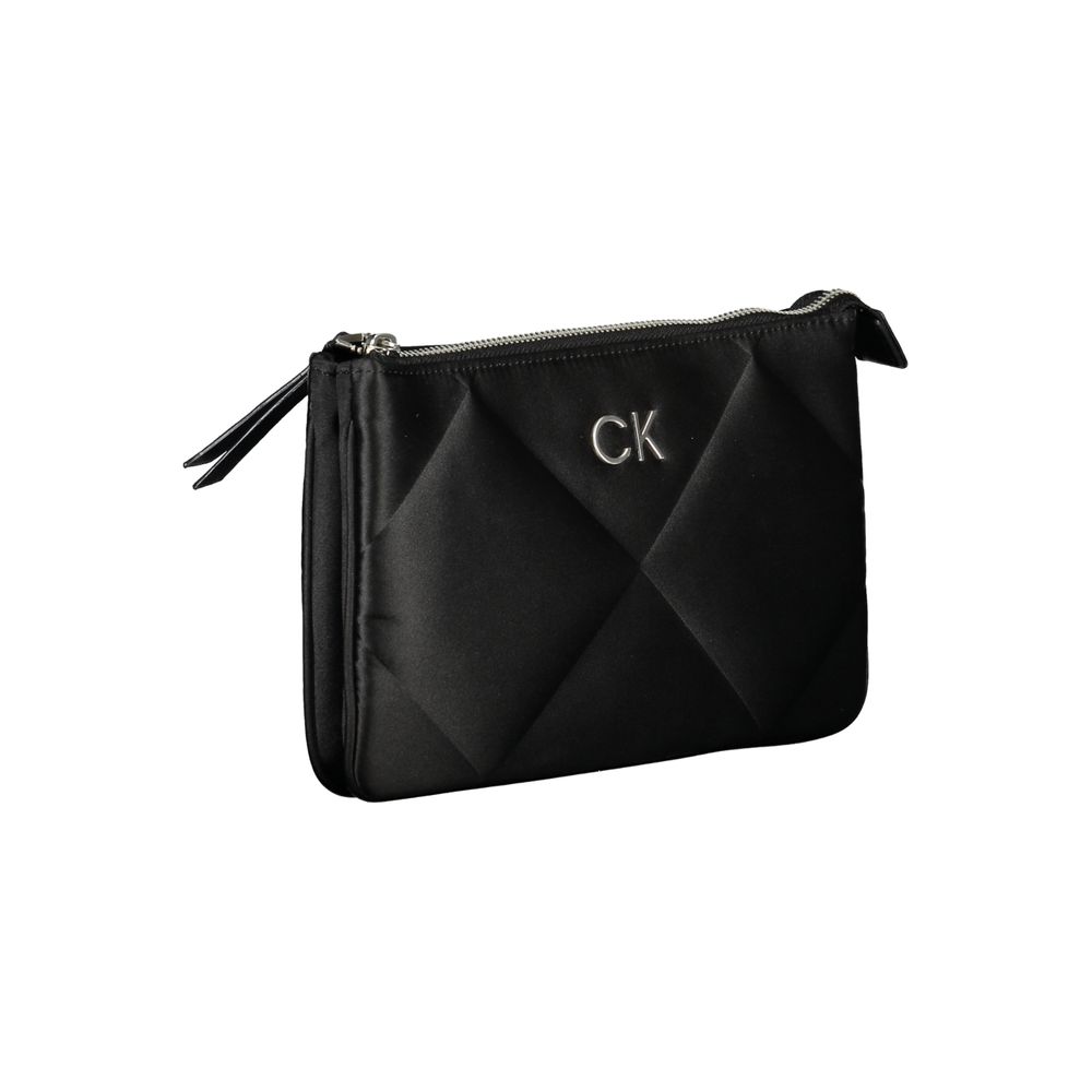 This Quilted Shoulder Handbag by Calvin Klein for women in polyester and black presents a sculptural silhouette featuring a secure zipper, ample built-in-compartments & cardholder, and versatile shoulder-strap & adjustable-strap for a sculptural finish.