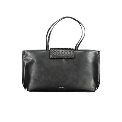 Tote Convertible Handbag by Calvin Klein for women in polyester faux leather black features an exquisite silhouette, showcasing a secure magnetic, ample internal-pockets, and exquisite handle for a sophisticated finish.