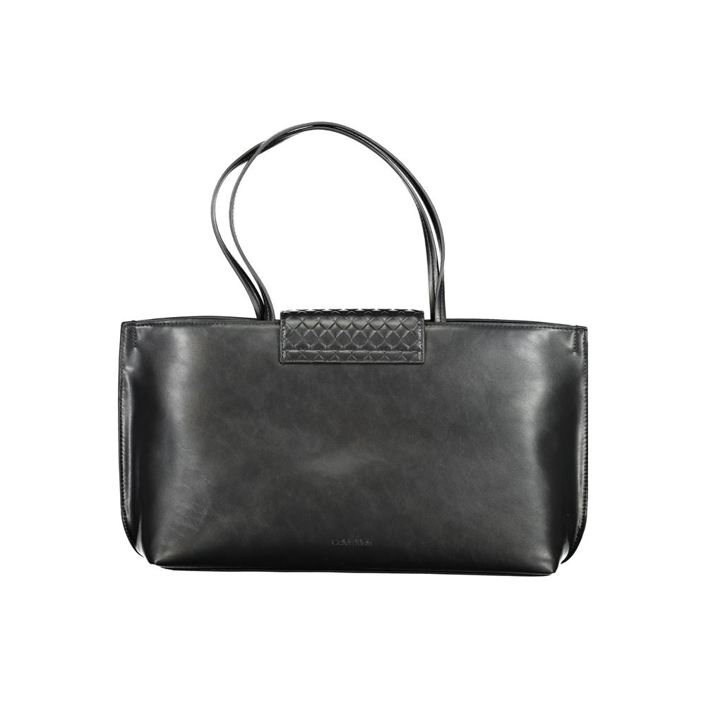 Tote Convertible Handbag by Calvin Klein for women in polyester faux leather black presents a exquisite silhouette, showcasing a secure magnetic and organized internal-pockets with versatile handle.