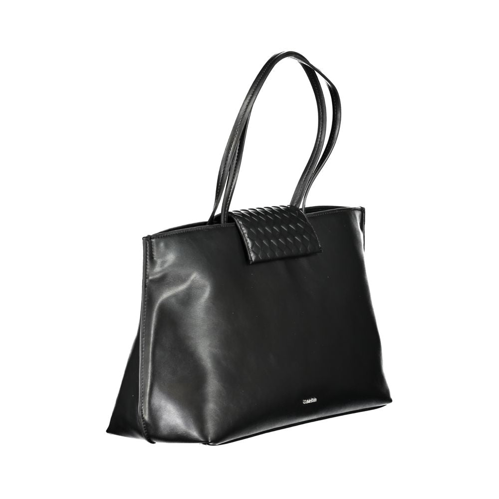 Tote Convertible Handbag by Calvin Klein for women in polyester faux leather black features an exquisite silhouette, showcasing a secure magnetic, ample internal-pockets, and versatile handle for exquisite style.