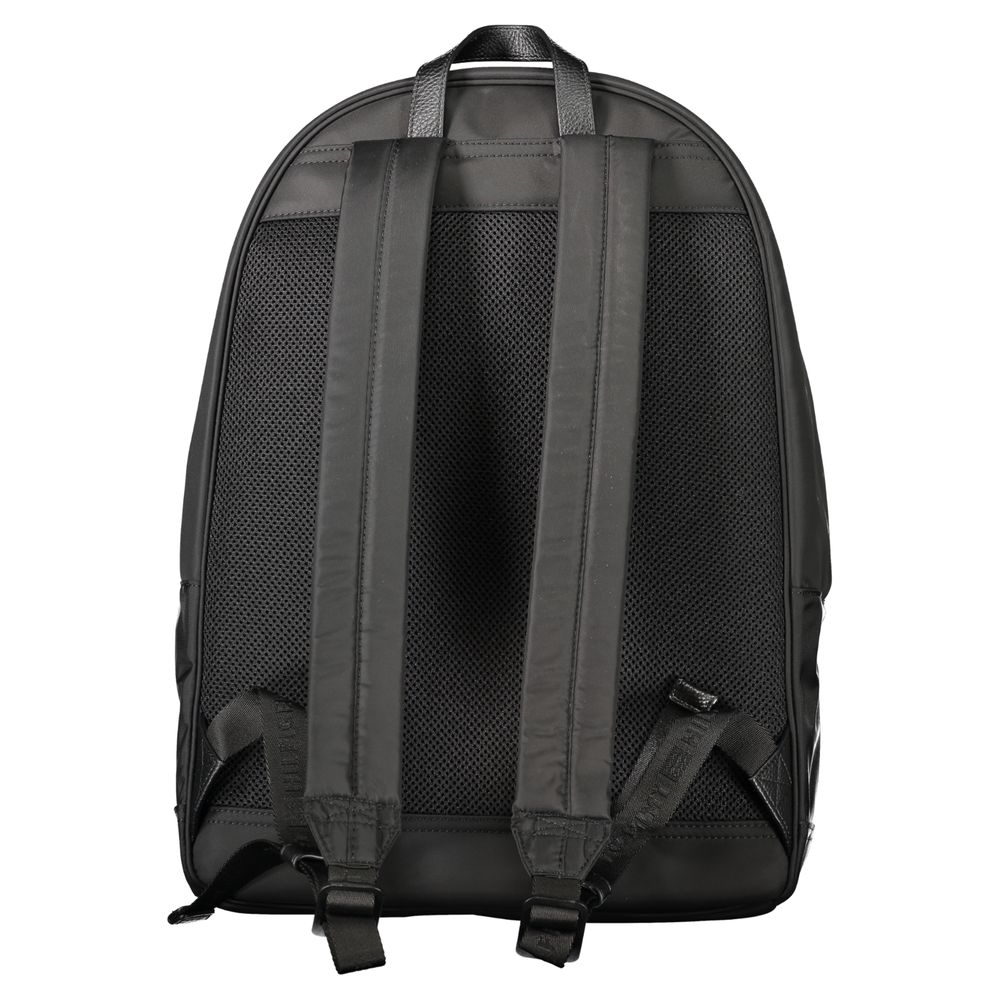 Backpack by Tommy Hilfiger for men in polyester black presents a stately Polyester Backpack design, showcasing a secure zipper with ample external-pockets, internal-pockets & laptop-compartment and versatile handle, backpack-strap & adjustable-strap for a stately finish.