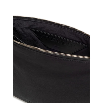Clutch Handbag by Bottega Veneta for men in nylon & leather black features a sculptural silhouette with a secure zipper, organized single-compartment & internal-pockets, and versatile handle for a sculptural finish.