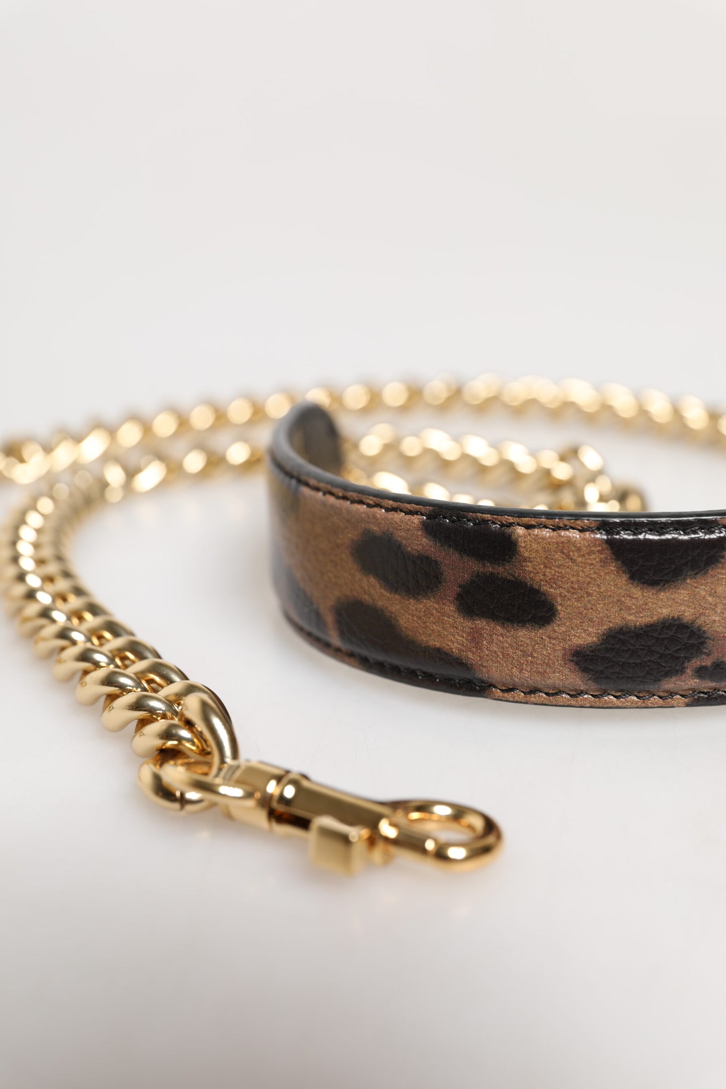 Shoulder Strap by Dolce & Gabbana for women in brass & calf leather brown & gold features a contemporary design, highlighting the distinctive style of the Brass Calf Leather Shoulder Strap with a contemporary finish.