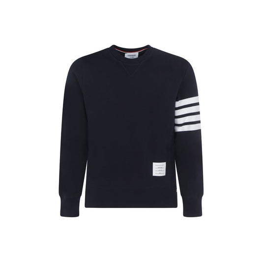Sweatshirt by Thom Browne for men in cotton blue, white, monogram & striped features an provocated silhouette, detailed with a provocated long-sleeve and a refined crew neckline for a sophisticated aesthetic.