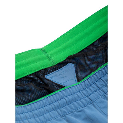 Swim Shorts by Bottega Veneta for men in polyamide & mesh blue showcases a captivating silhouette, expertly capturing the sophisticated essence of the captivating Men's Polyamide & Mesh Swim Shorts design for a premium poolside look.
