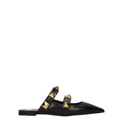 Mules Sandals Flat Shoes by Valentino Garavani for women in leather black & gold showcases a dynamic silhouette, artfully capturing Women's Leather Mules Sandals Flat Shoes through its distinctive and elegant .