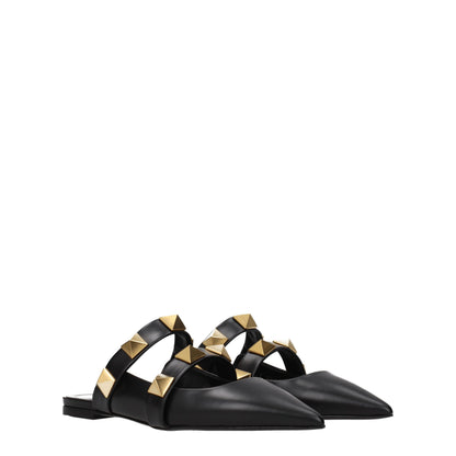 Mules Sandals Flat Shoes by Valentino Garavani for women in leather black & gold features an statuesque silhouette from the Women's Leather Mules Sandals Flat Shoes collection, showcasing a and a statuesque for a statuesque look.
