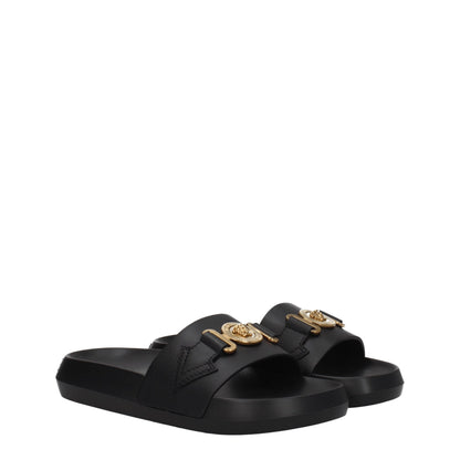 Flat Clogs Sandals by Versace for women in black & gold presents a sculptural silhouette, showcasing the Women's Leather & Rubber Flat Clogs Sandals design with a sculptural flat and open toe style for a premium look.