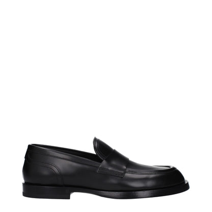 Flat Loafer Shoes by Dolce & Gabbana for men in leather black features an effortless chic silhouette, showcasing the Men's Leather Flat Loafer Shoes design with an effortless chic flat and a round toe style for a effortless chic look.