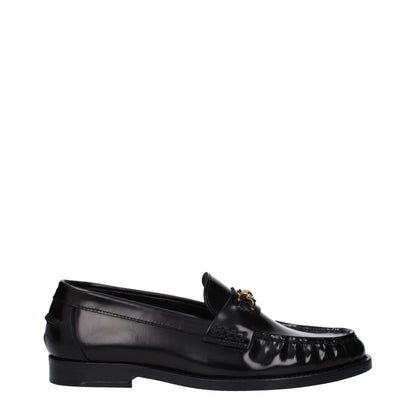 Flat Loafer Slip-On Shoes by Versace for women in leather black showcases a timeless silhouette from the Women's Leather Flat Loafer Slip-On Shoes collection, featuring a timeless flat and round toe style for a timeless finish.