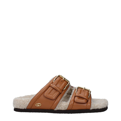 Flat Clogs Sandals by Valentino Garavani for women in leather & rubber brown features an architectural design from the Women's Leather & Rubber Flat Clogs Sandals collection, defined by a architectural flat and almond open toe style for a architectural finish.