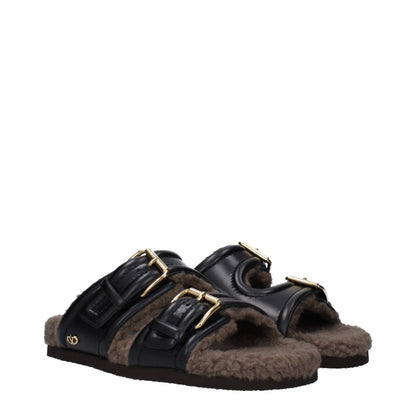 Flat Clogs Slippers by Valentino Garavani for women in leather & rubber black features an effortless chic silhouette from the Women's Leather & Rubber Flat Clogs Slippers collection, showcasing a flat and effortless chic open toe style.