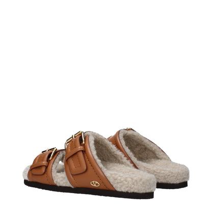 Flat Clogs Sandals by Valentino Garavani for women in leather & rubber brown features an architectural design from the Women's Leather & Rubber Flat Clogs Sandals collection, defined by a architectural flat and almond open toe style for a architectural finish.