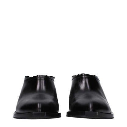 Mules Loafers Flat Shoes by Moschino for women in leather & rubber black showcases a resplendent Women's Leather & Rubber Mules Loafers Flat Shoes aesthetic with a and .