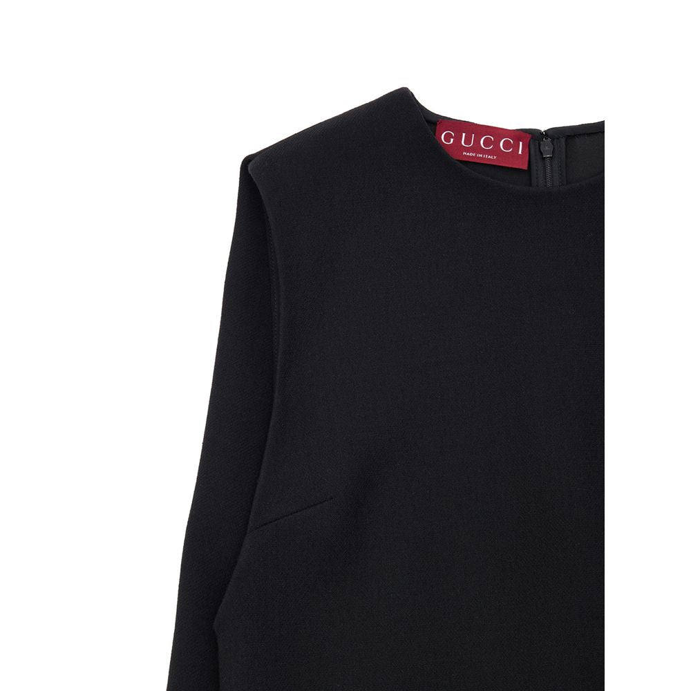 Dress by Gucci for women in wool black features a dramatic silhouette, showcasing an elegant round neckline and that flows into a dramatic short.