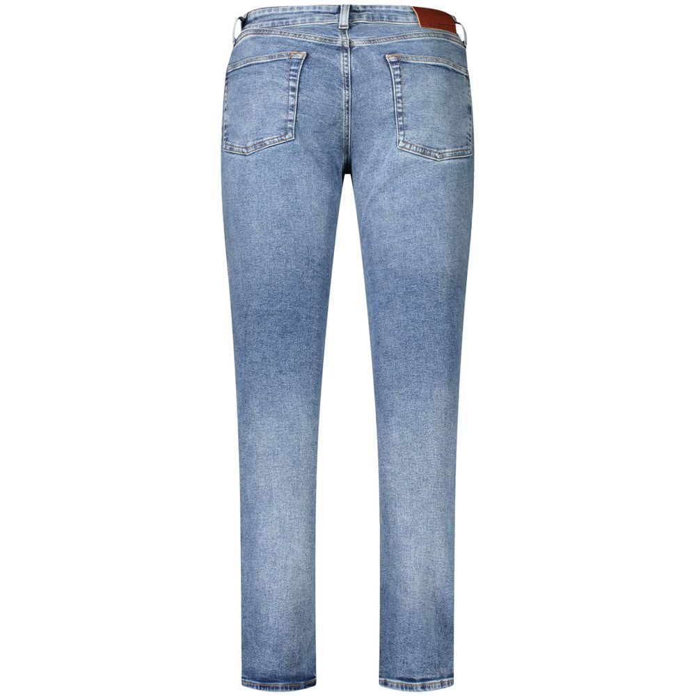 Jeans by Tommy Hilfiger for men in stretch cotton blue features a polished silhouette with a polished slim, reaching a polished long and finished with a polished .
