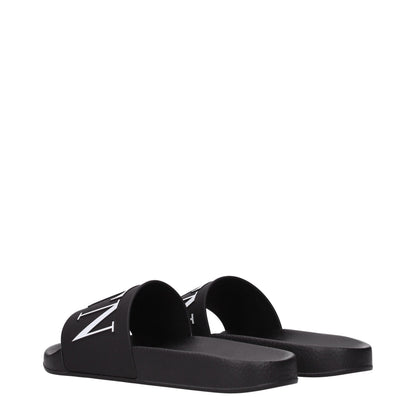 Flat Clogs Sandals by Valentino Garavani for men in cotton & rubber and black presents a captivating silhouette, showcasing the signature style of the Men's Cotton & Rubber Flat Clogs Sandals with a captivating flat and captivating open toe style.
