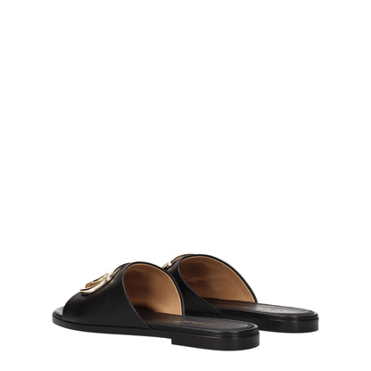 Flat Clogs Sandals by Off-White for women in leather black, gold & white features an exquisite silhouette, showcasing the exquisite Women's Leather Flat Clogs Sandals with a flat and open toe style.