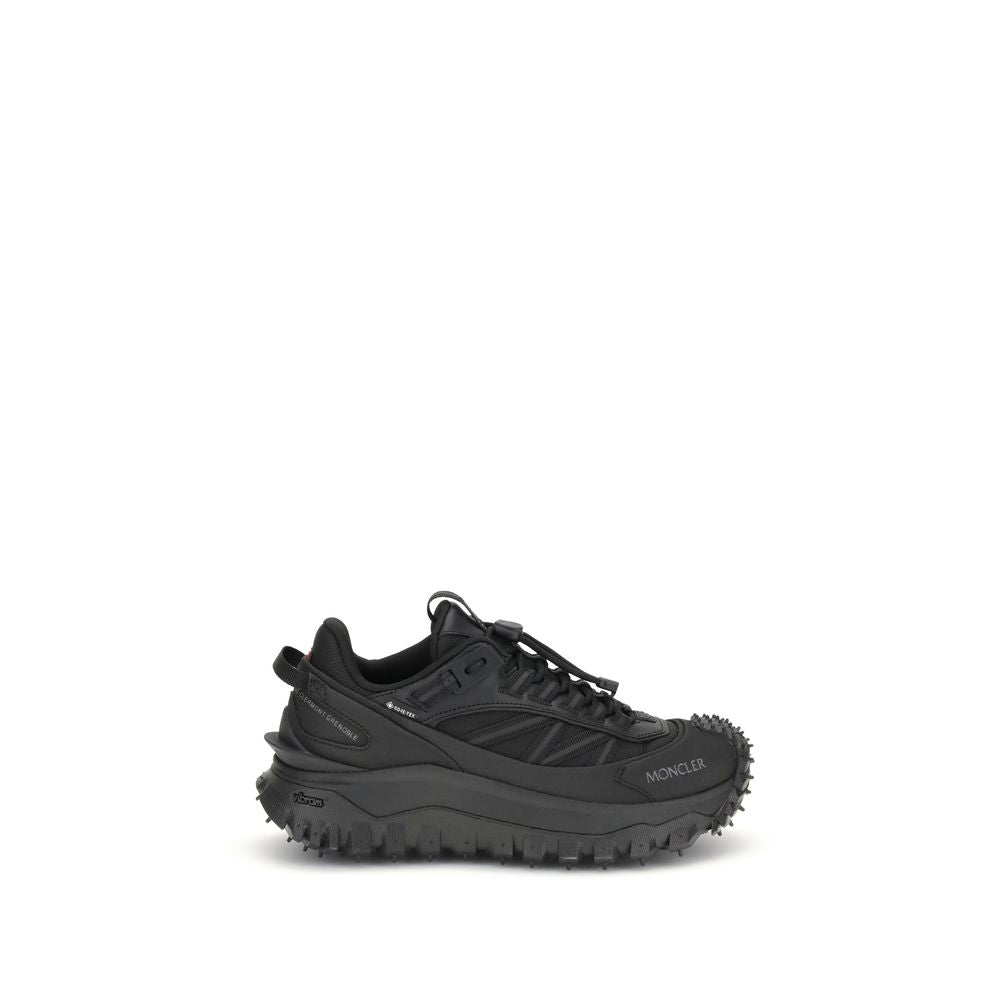 Athletic Sneakers by Moncler for women in bos taurus calf leather & polyester black & print showcases a architectural silhouette, artfully capturing the essence of the Women's Low Top Bos Taurus Calf Leather & Polyester Athletic Sneakers with its signature architectural low-top style construction.