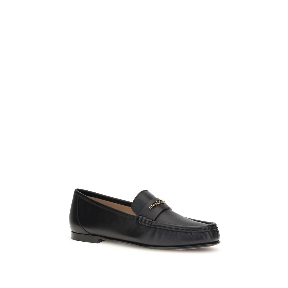 Loafer Shoes by Chloé for unisex in bos taurus calfskin leather black & gold showcases a timeless silhouette from the Unisex Bos Taurus Calfskin Leather Loafer Shoes collection, featuring a timeless and for a timeless finish.