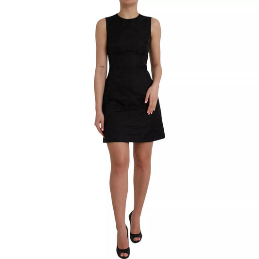Dress by Dolce & Gabbana for women in cupro nylon & elastane black presents a sinuous silhouette, showcasing a sophisticated round neckline and sleeveless detailed with a sinuous mini for a refined finish.