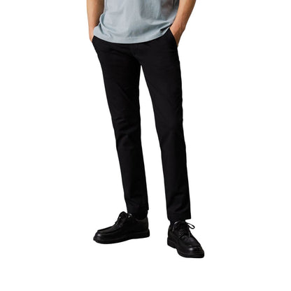 Pants by Calvin Klein Jeans for men in stretch cotton black features a stylish silhouette with a stylish tapered-leg & regular-fit, long, and .