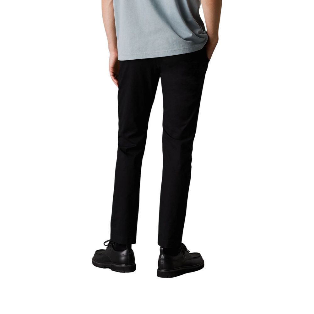 Pants by Calvin Klein Jeans for men in stretch cotton black features a sleek silhouette with a sleek tapered-leg & regular-fit, a refined long, and a sophisticated finish.