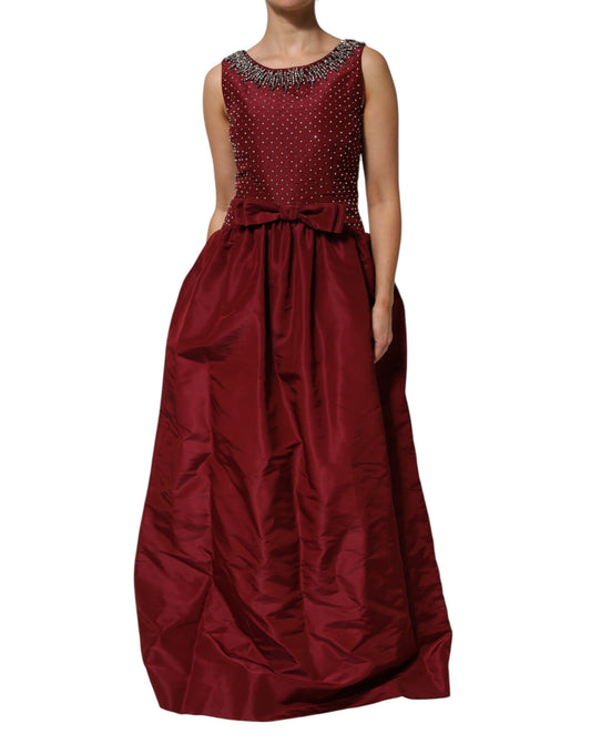 Dress by Dolce & Gabbana for women in glass polyester & silk burgundy features a dramatic silhouette, showcasing an elegant and sleeveless that flows into a dramatic long.